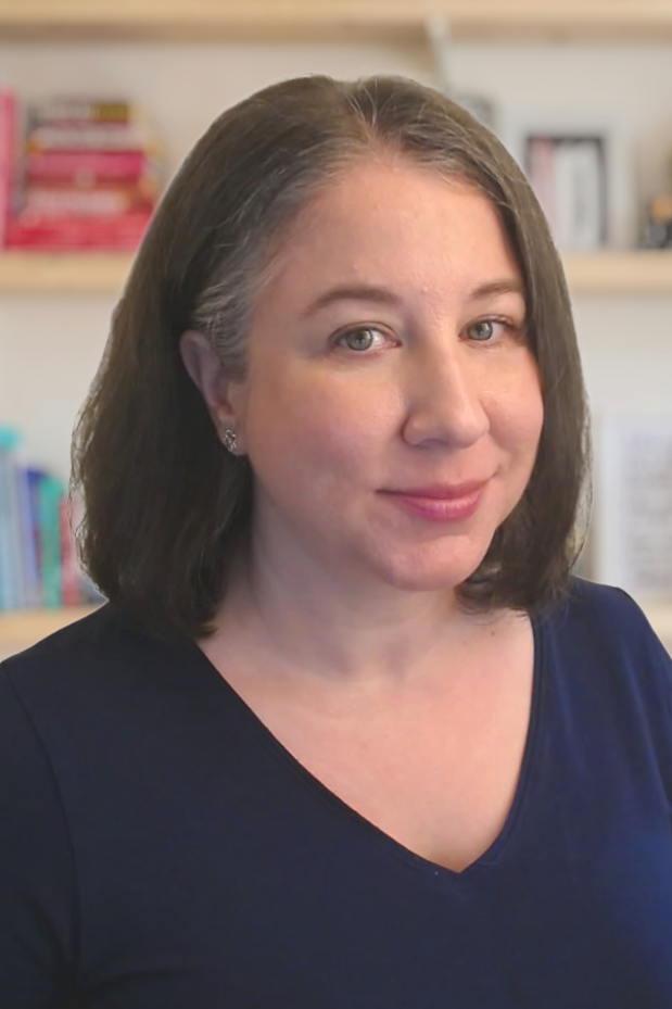 Courtney Dahlke Headshot, staring into camera with bookcase in the background 